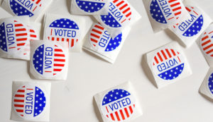 A collection of 1 voted stickers on a white surface.