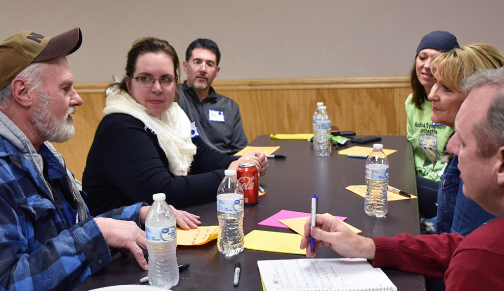 People sit at a table in discussion at Your Voice Ohio event.